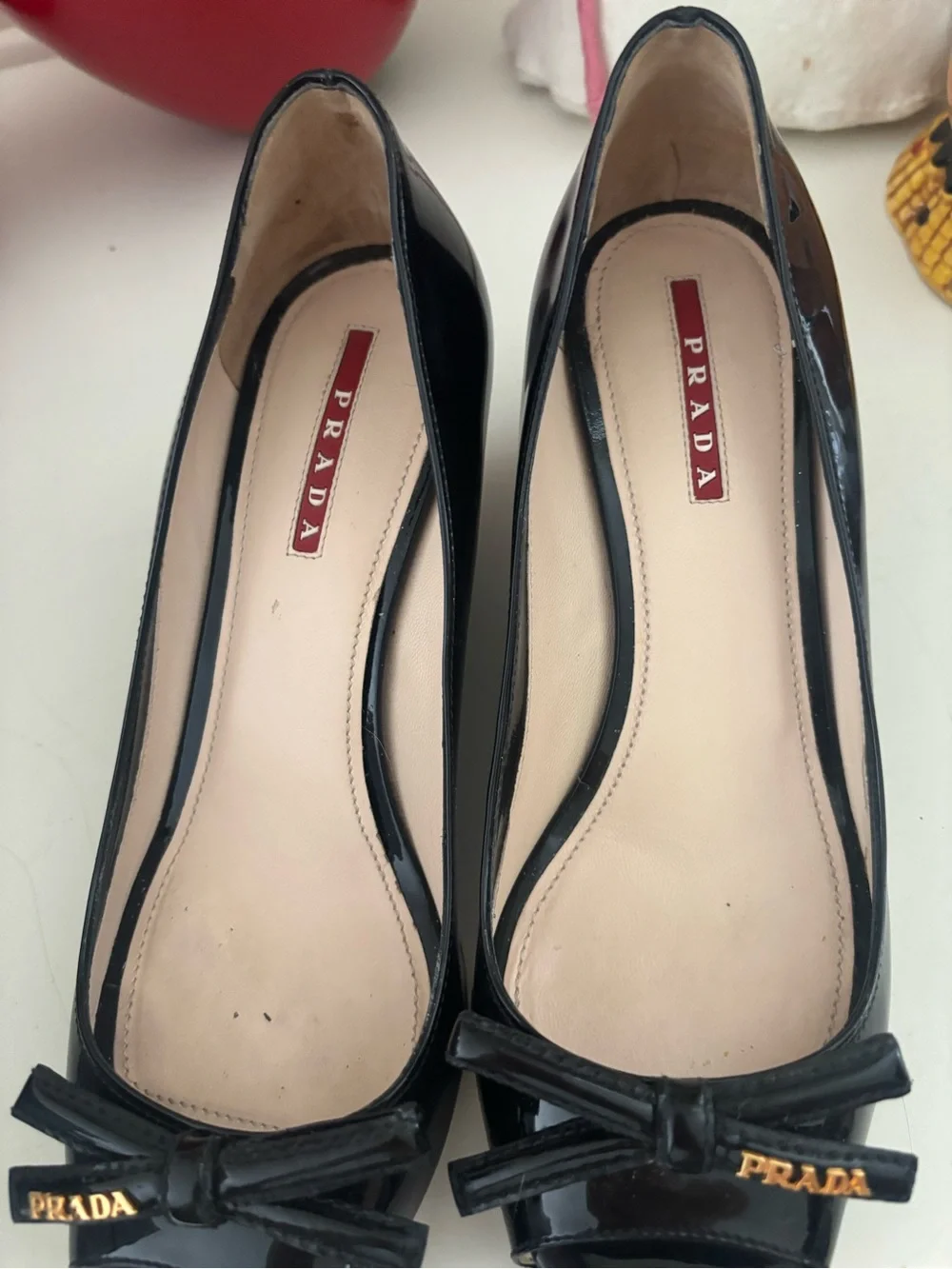 Prada Black Patent Leather Peep-Toe Wedges with Bow and Gold Accent